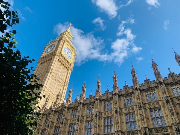 Looking up at Westminster’s parliamentary buildings and a blue sky
